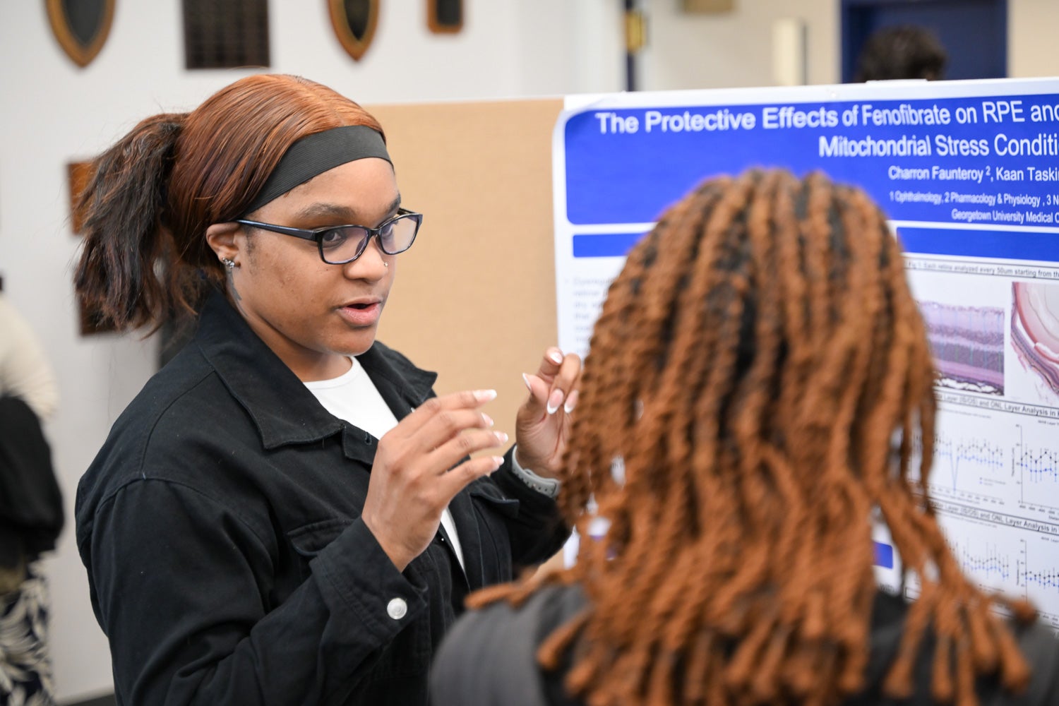 A student presents research at Pharmacology & Physiology Poster Day
