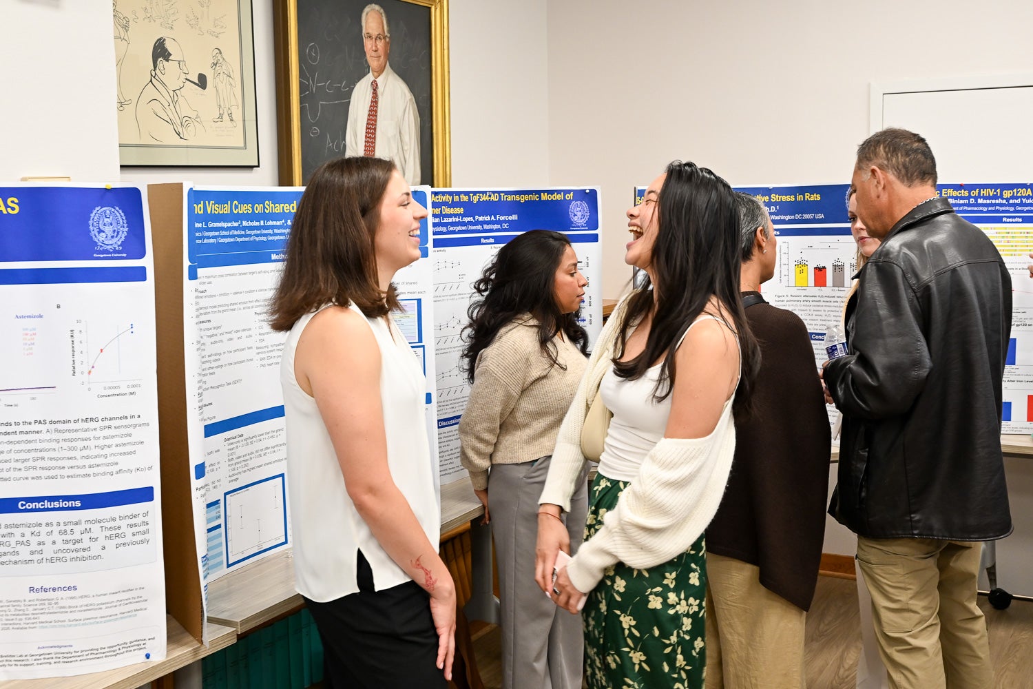 Attendees talk at Pharmacology & Physiology Poster Day