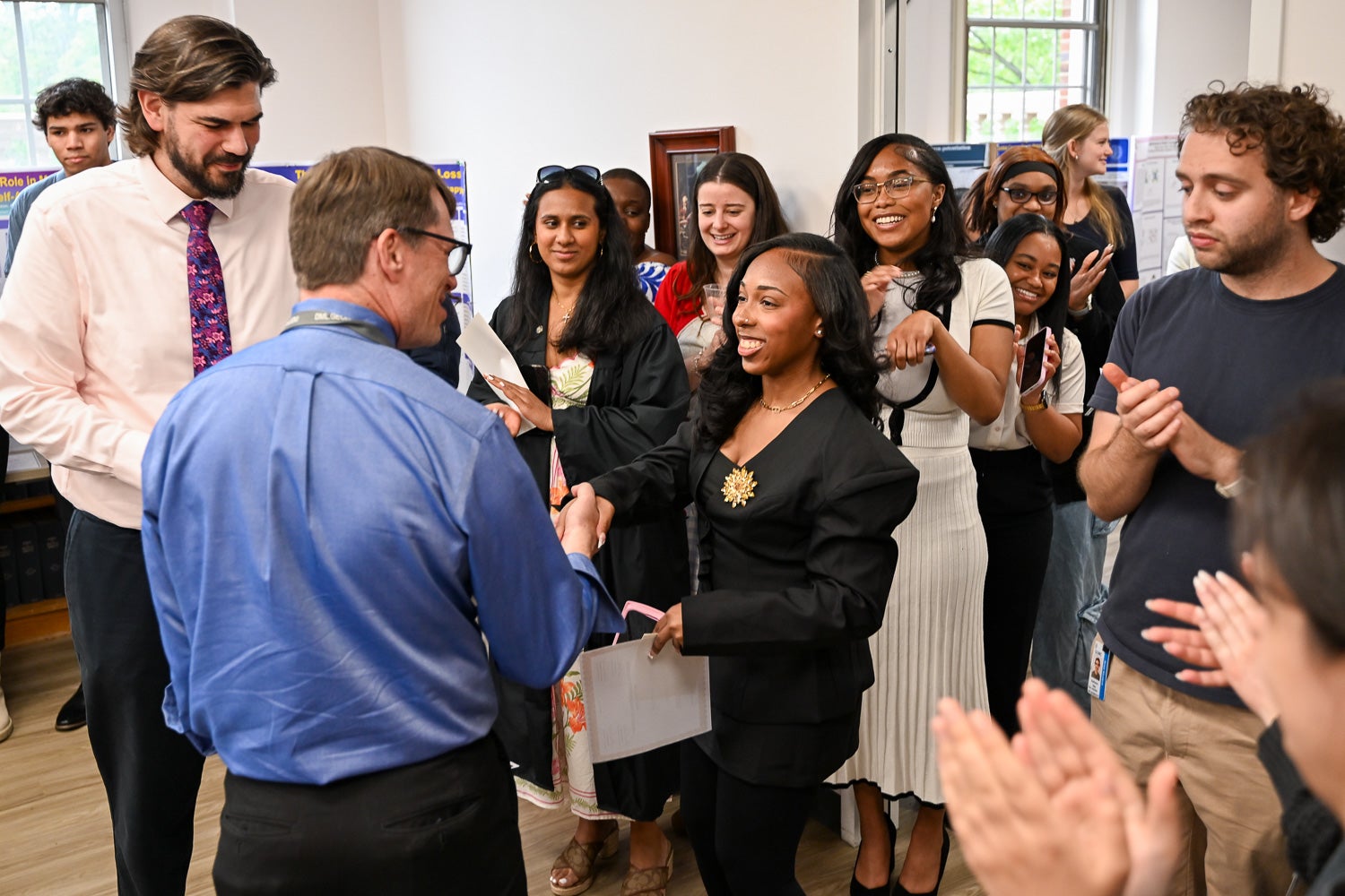 A student receives an award at Pharmacology & Physiology Poster Day