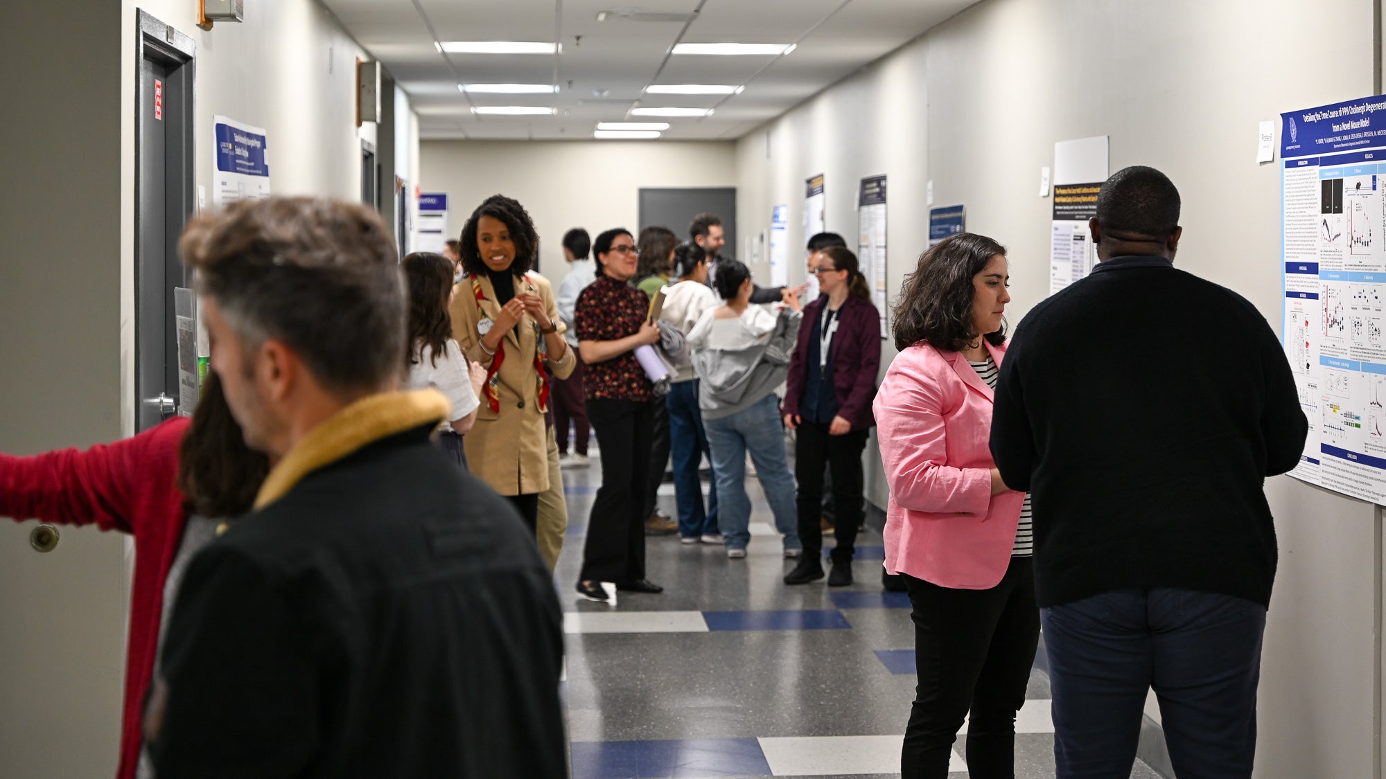 Postdoctoral Research Symposium attendees during the hallway poster session