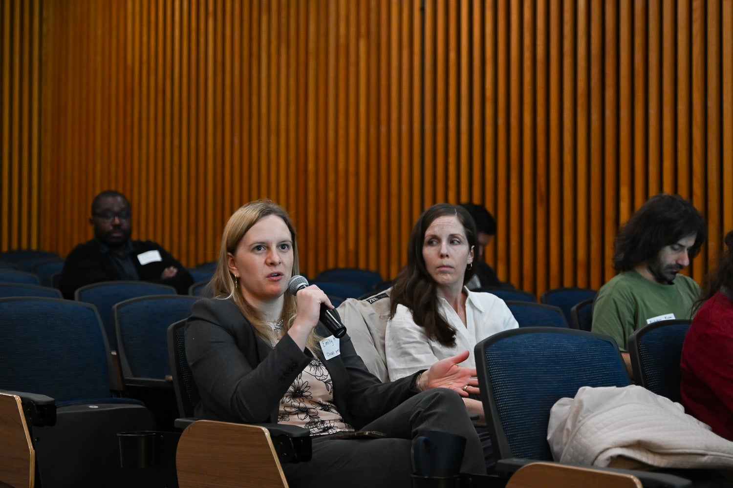 A Postdoctoral Research Symposium attendee asks a question during an oral presentation