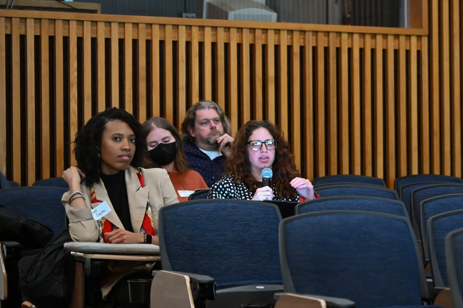 A Postdoctoral Research Symposium attendee asks a question during an oral presentation