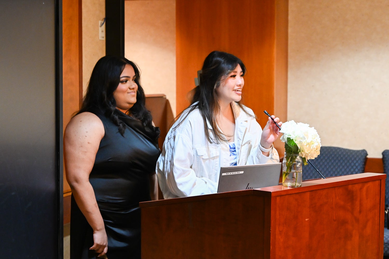Students speak from the lectern at the Systems Medicine Gala